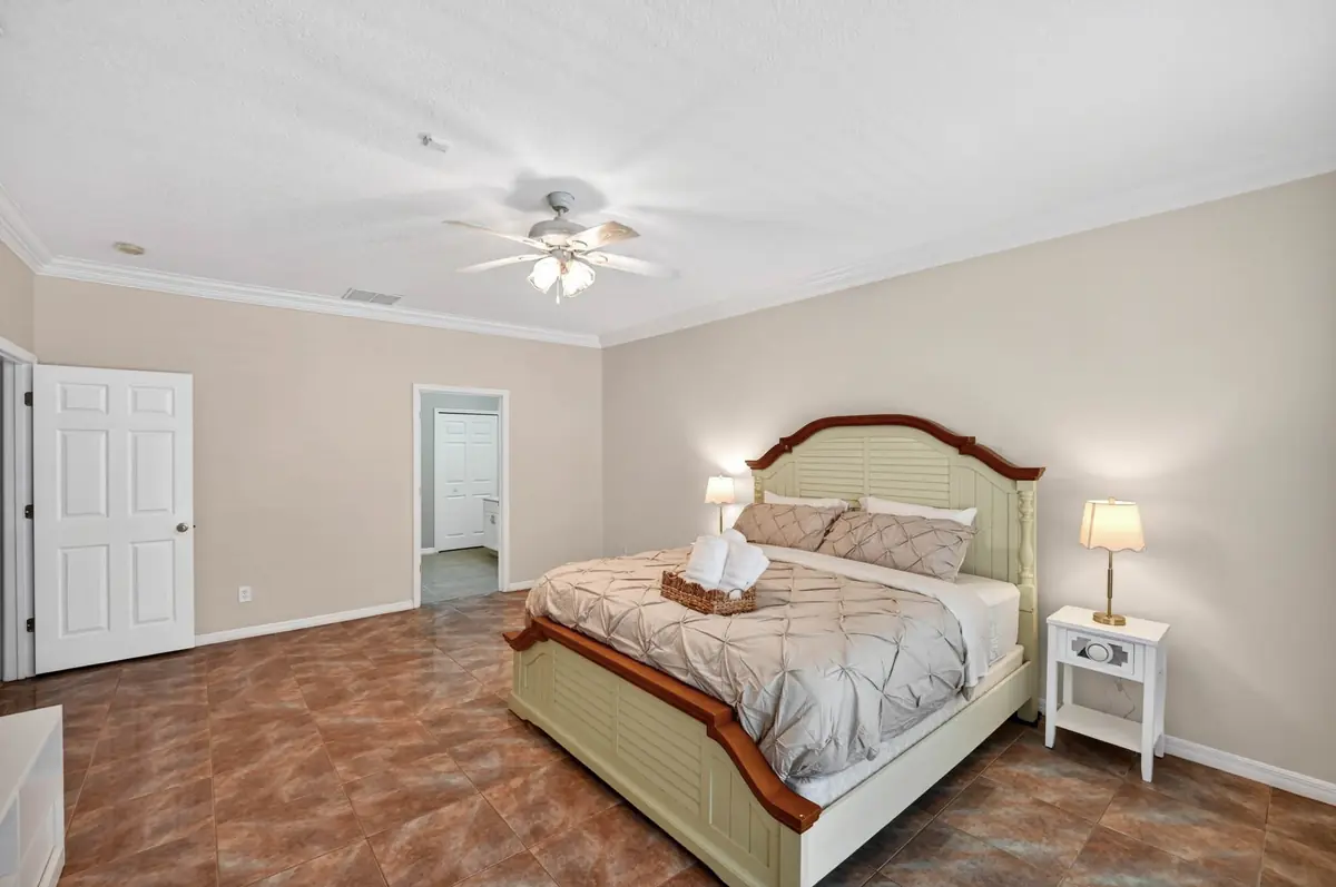 Primary bedroom with a wood-framed bed and bedside lamps