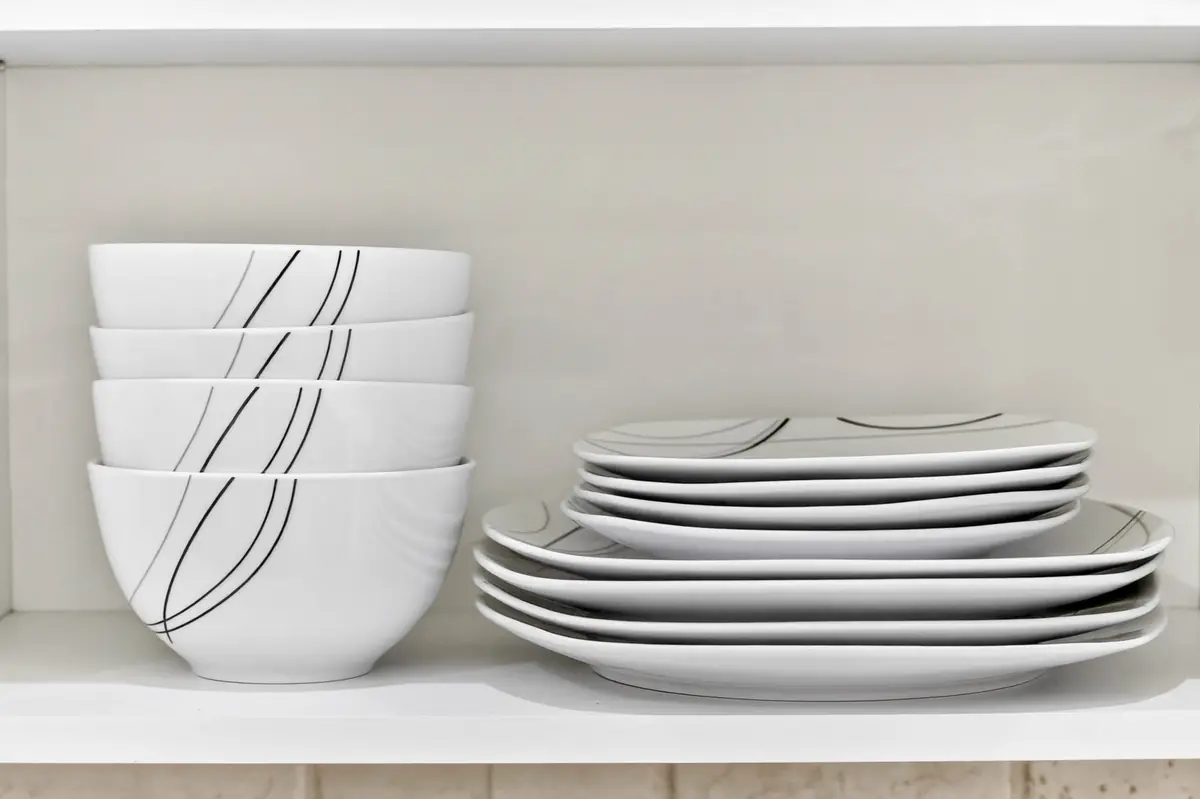 Stacked white bowls and plates