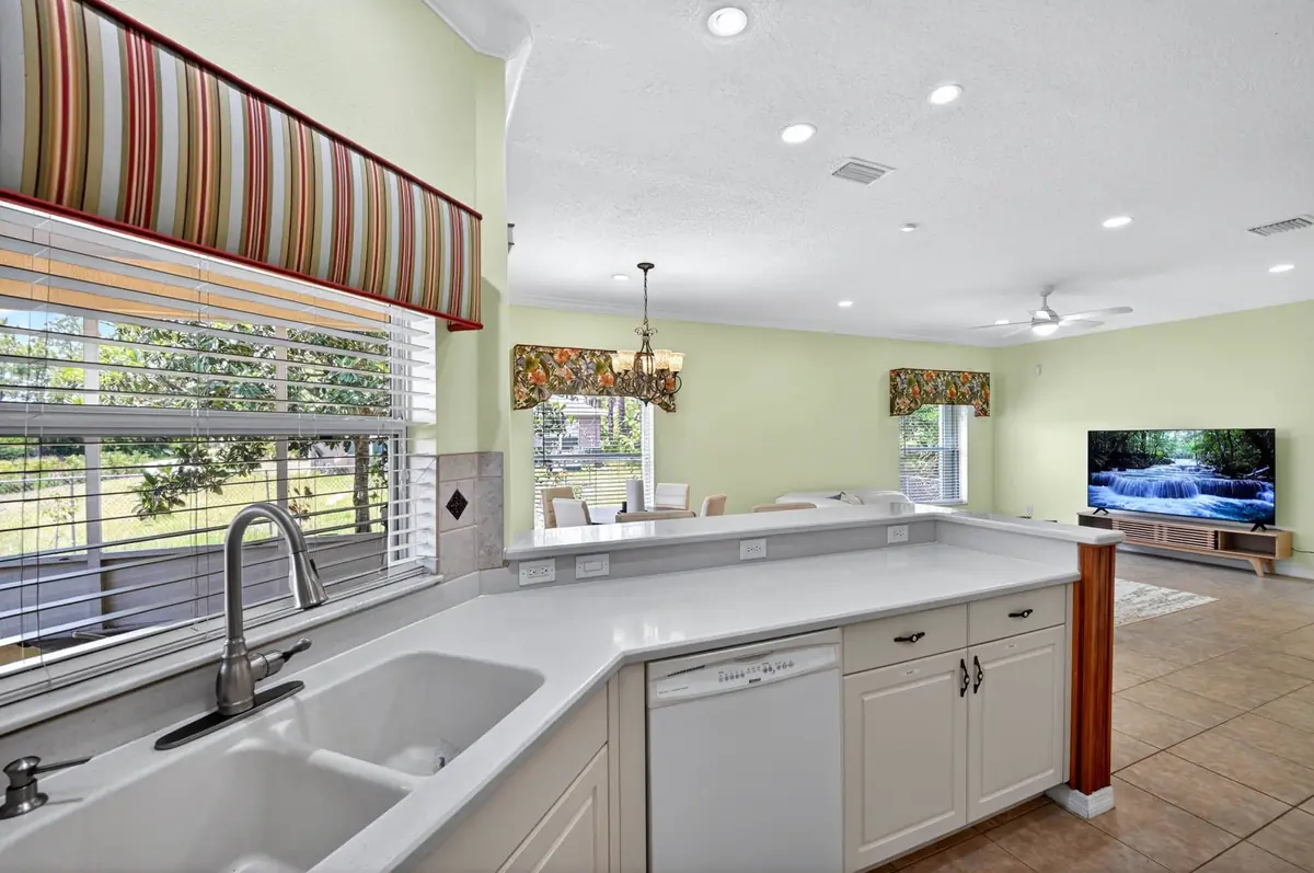 Kitchen sink under a window with a view of the yard