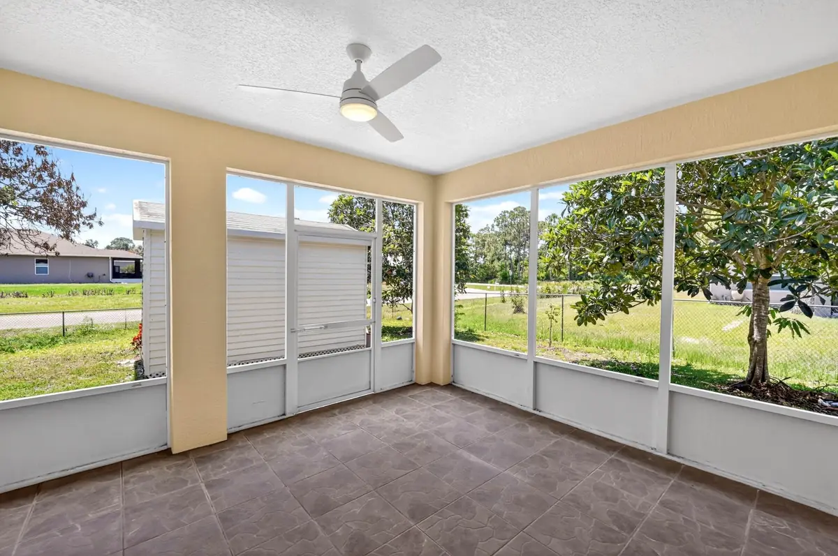 Screened room with large windows looking out to the yard